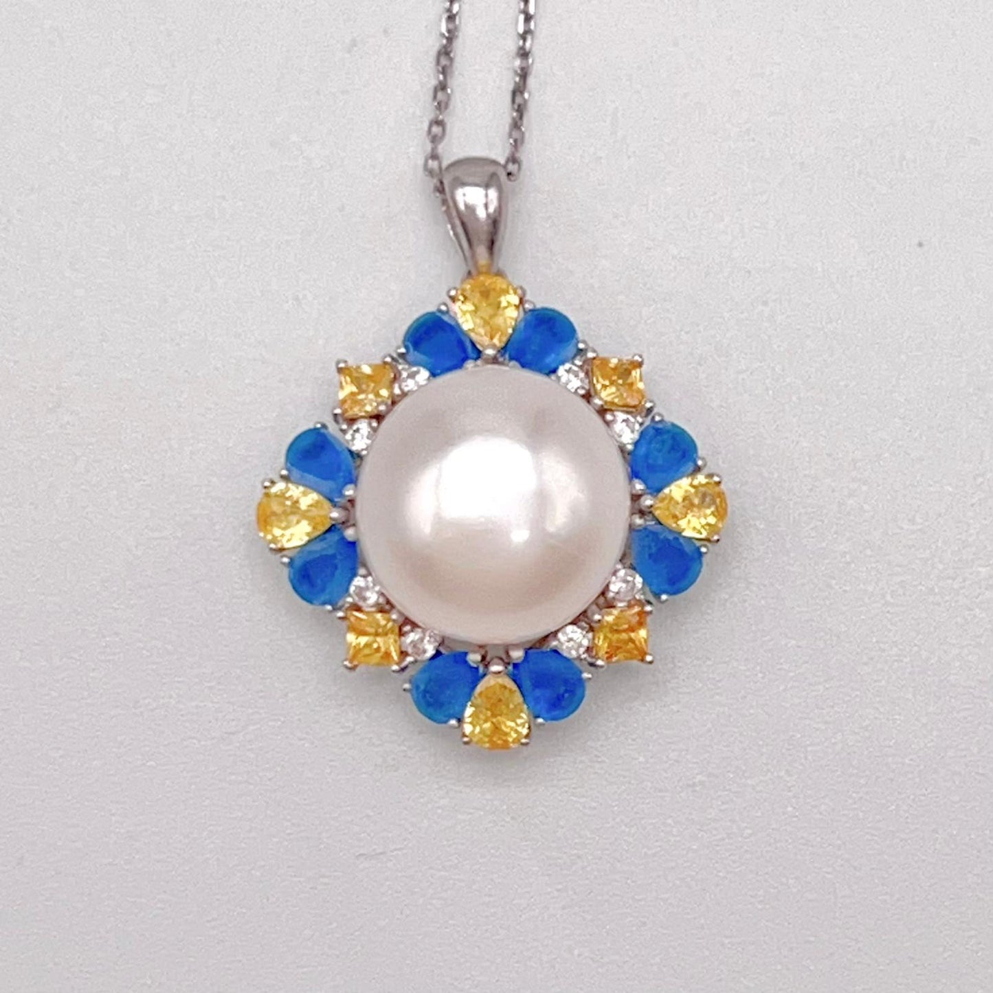 Retro Wind. Pearl Ring and Pendant set in Silver 925. Blue yellow Zircon