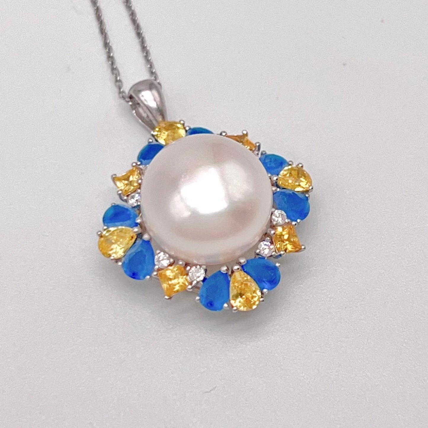Retro Wind. Pearl Ring and Pendant set in Silver 925. Blue yellow Zircon