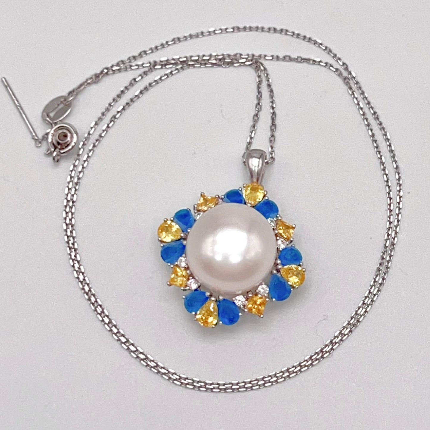 Retro Wind. Pearl Ring and Pendant set in Silver 925. Blue yellow Zircon