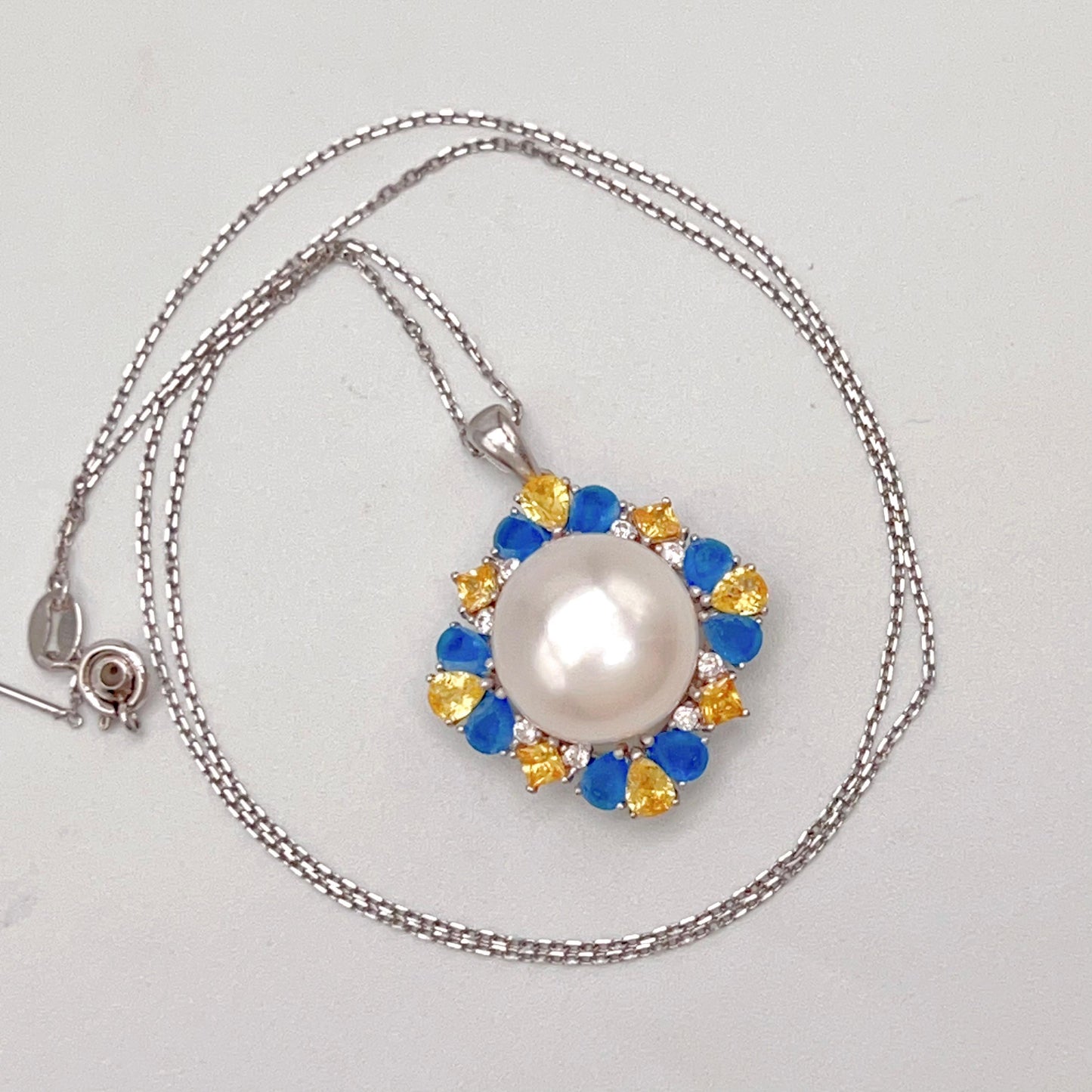 Retro Wind. Pearl Ring and Pendant set in Silver 925. Blue yellow Zircon
