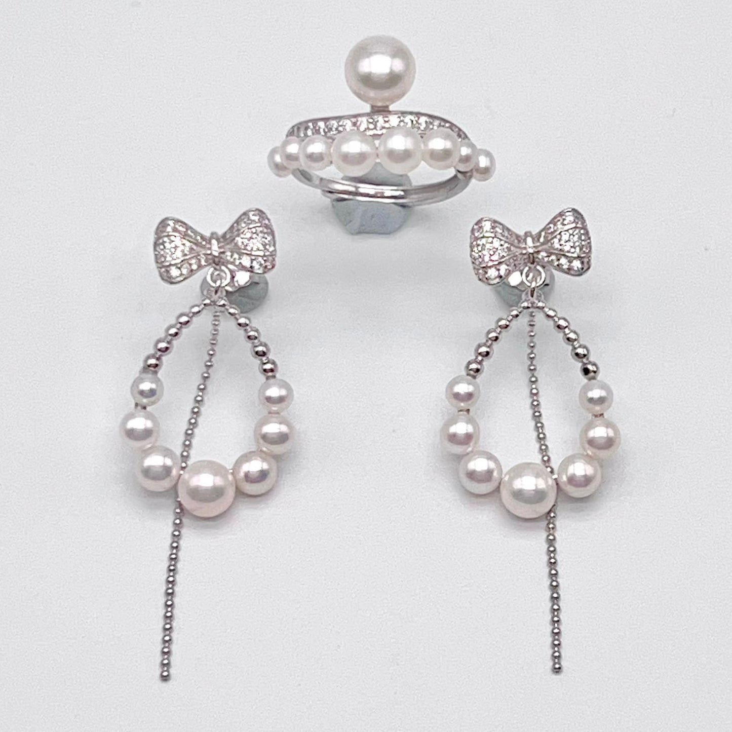 Retro Wind. Pearl Earring and Ring set in Silver 925. Bow & Swing