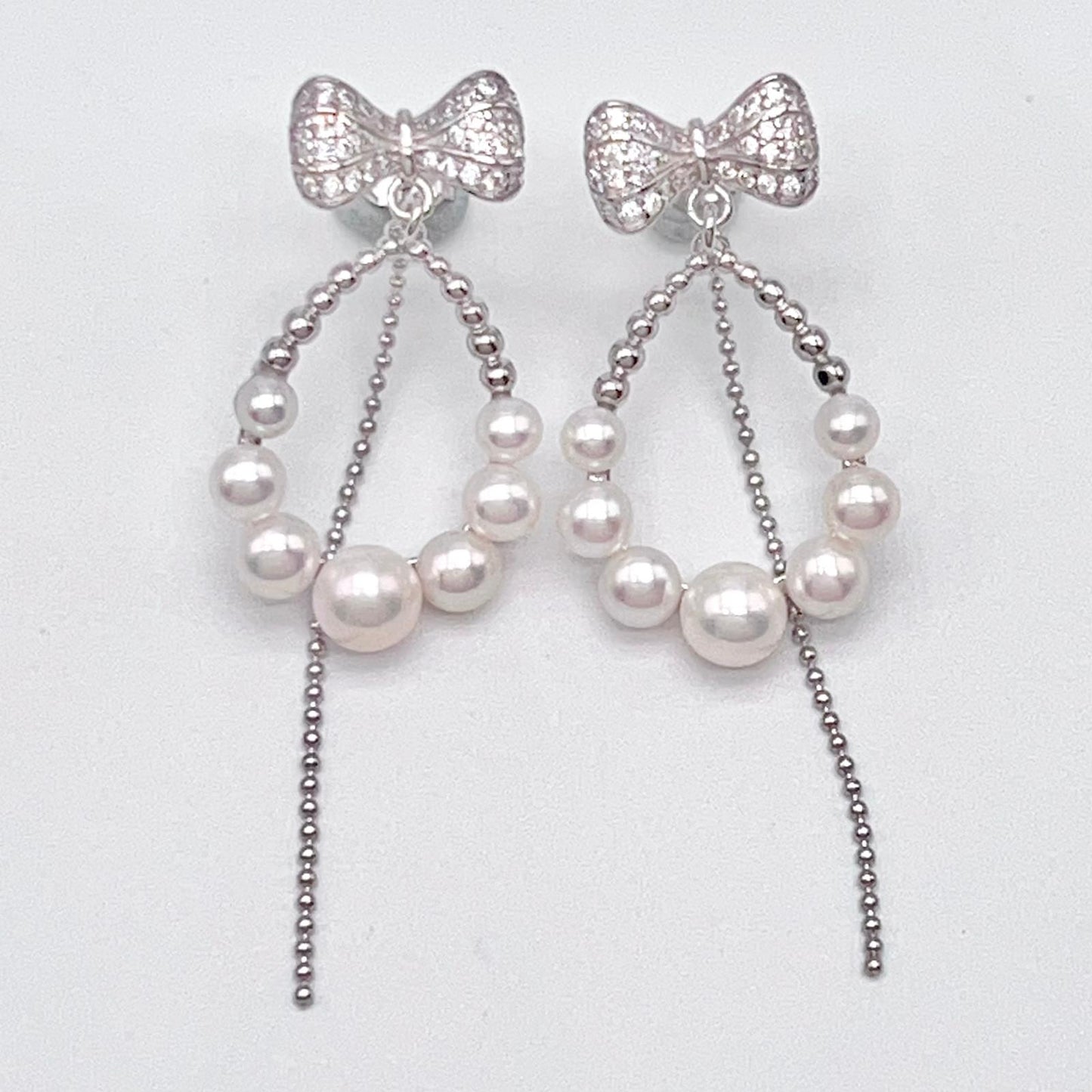 Retro Wind. Pearl Earring and Ring set in Silver 925. Bow & Swing
