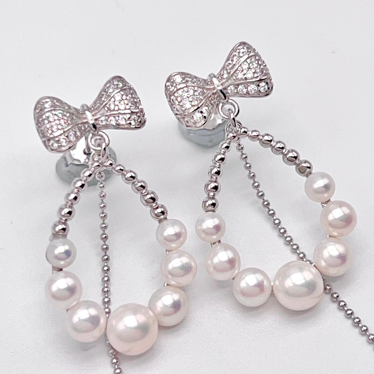 Retro Wind. Pearl Earring and Ring set in Silver 925. Bow & Swing