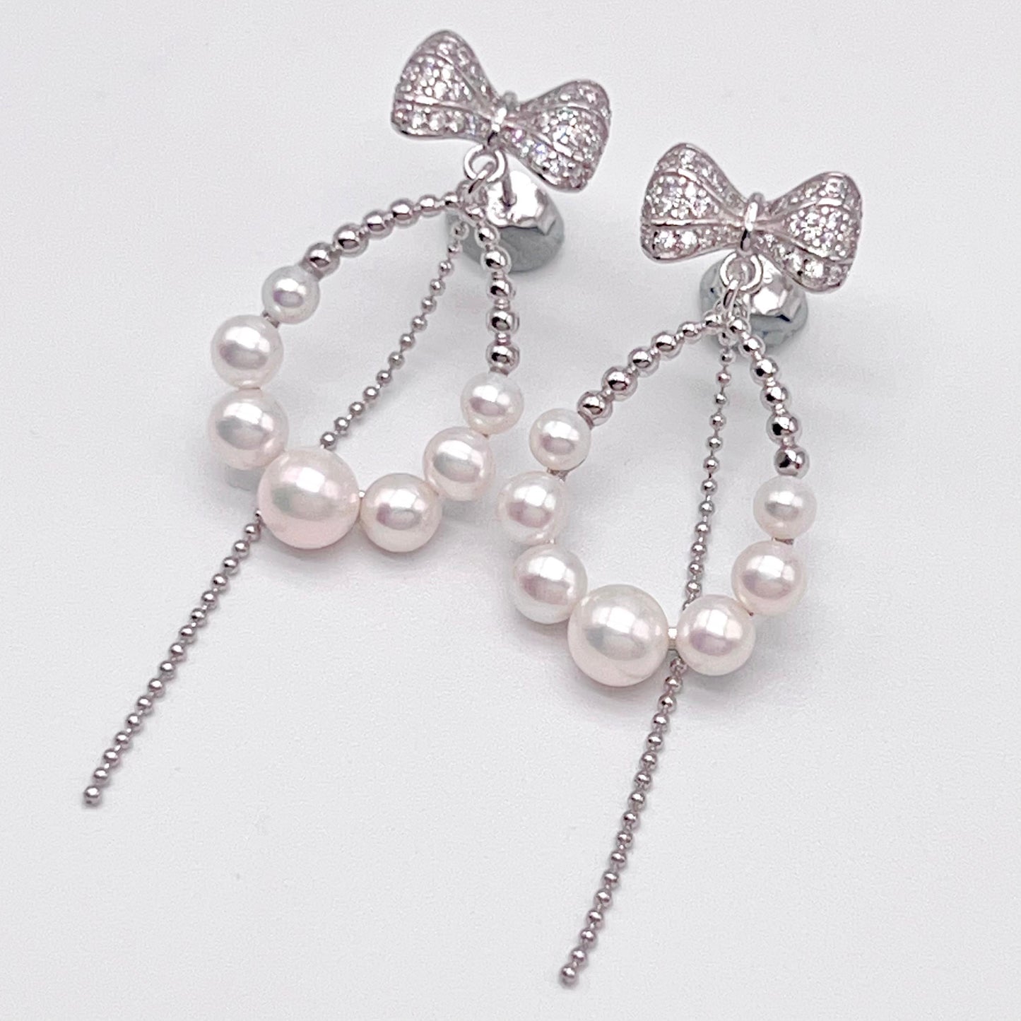 Retro Wind. Pearl Earring and Ring set in Silver 925. Bow & Swing