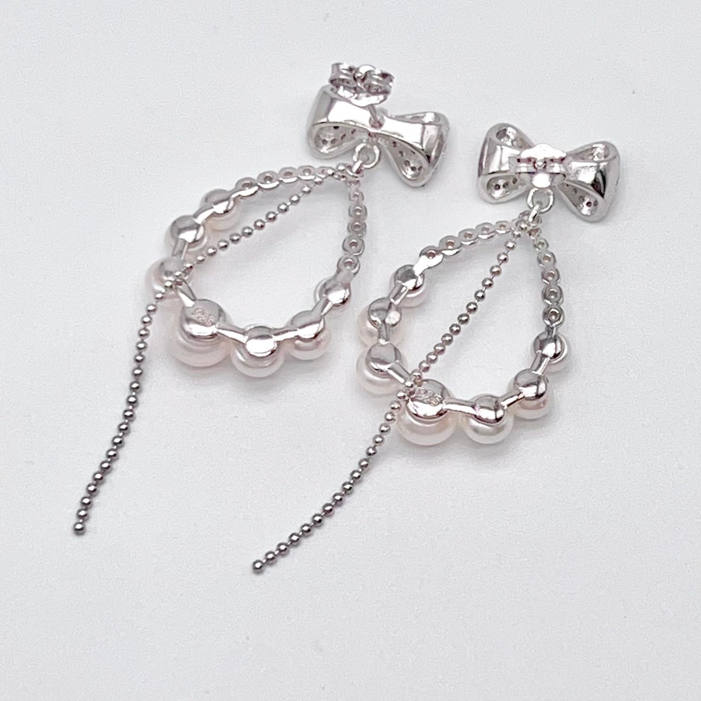 Retro Wind. Pearl Earring and Ring set in Silver 925. Bow & Swing
