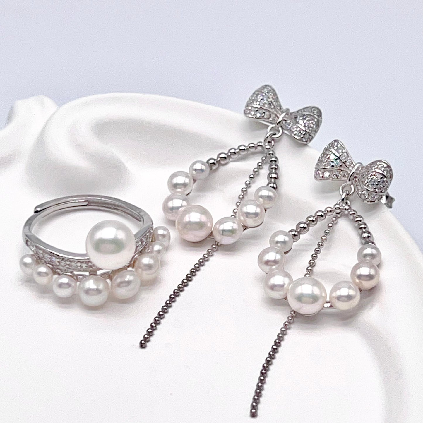 Retro Wind. Pearl Earring and Ring set in Silver 925. Bow & Swing