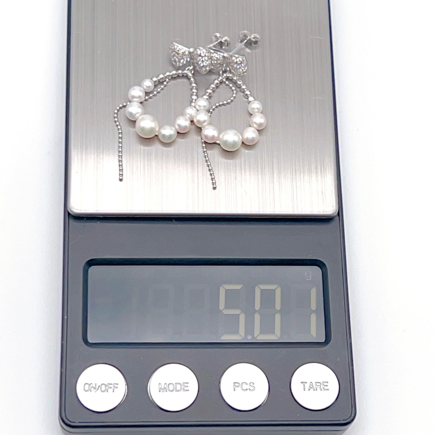 Retro Wind. Pearl Earring and Ring set in Silver 925. Bow & Swing