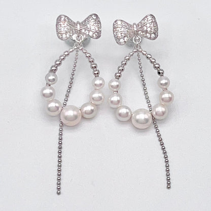 Retro Wind. Pearl Earring and Ring set in Silver 925. Bow & Swing